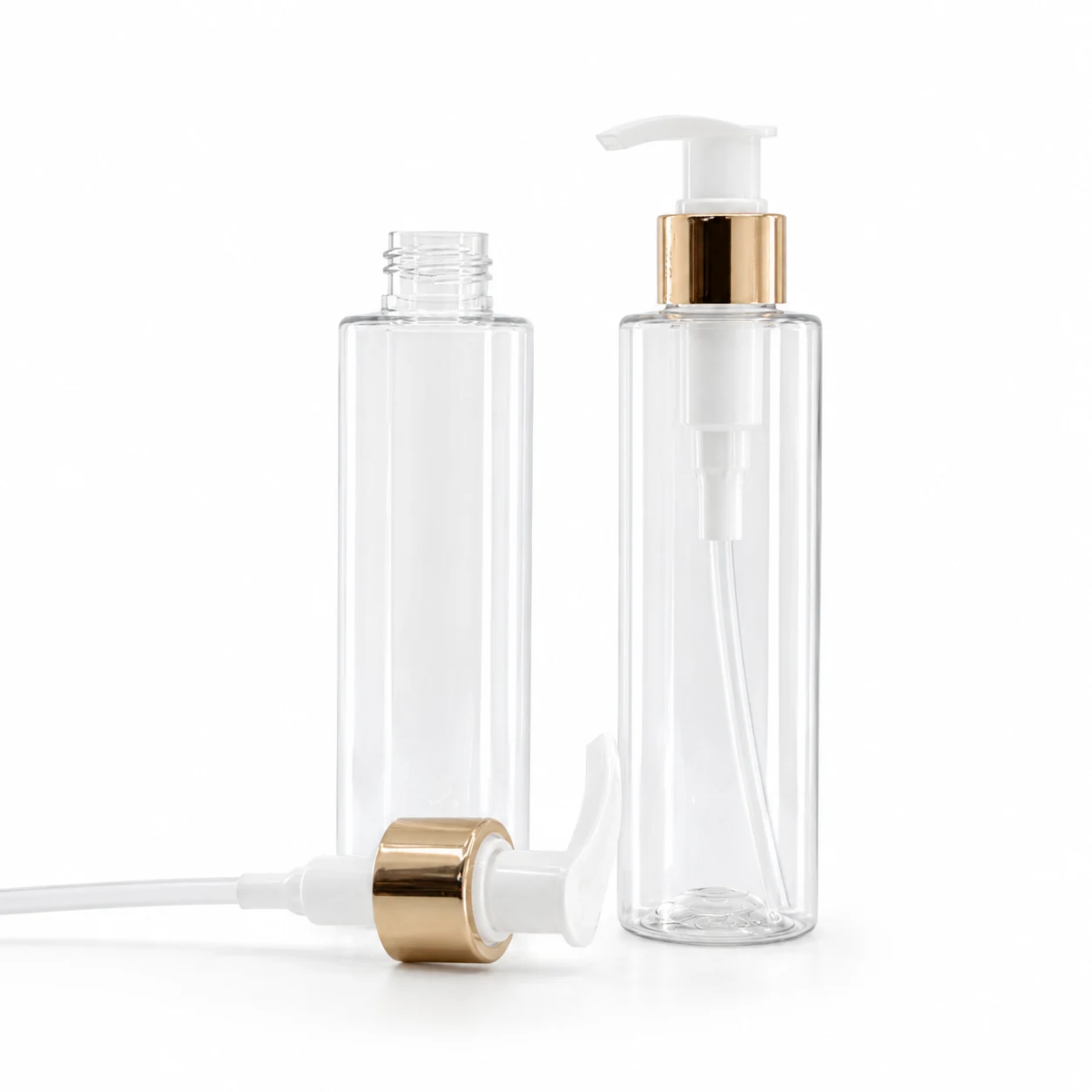 Kunststofffläschchen, transparent, weiße Lotionpumpe mit glänzendem goldenem Kragen, 100 ml