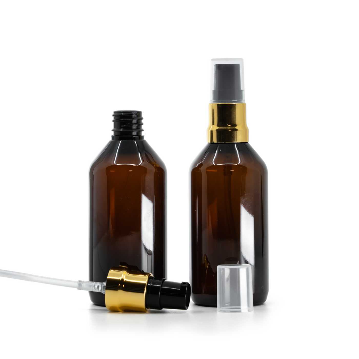 Flacon en plastique ambré avec pompe noire et dorée brillante et capot transparent, 115 ml