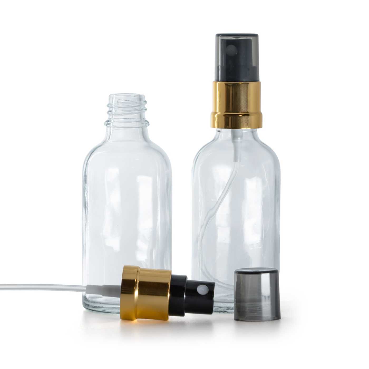 Butelka szklana, przezroczysta, czarno-złoty atomizer, przydymiony kapturek, 50 ml